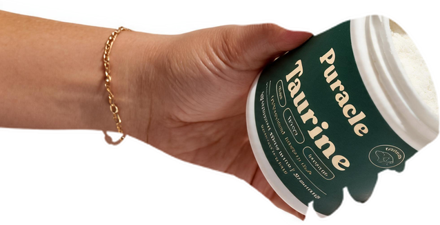 A hand holding a tub of PawClover Taurine